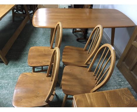 An Ercol dining table, 4 stick back chairs and a sideboard (conditional general good, watermark on table, and some wear on se