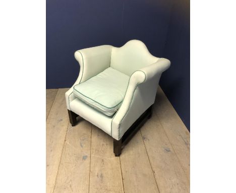Low, deep seated arm chair with scrolling arms, and square legs to castors, in light green upholstery (condition, upholstery 