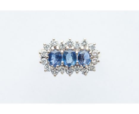 three claw set sapphires surrounded by 18 round claw set diamonds, ring size M, total weight 4.5 grams