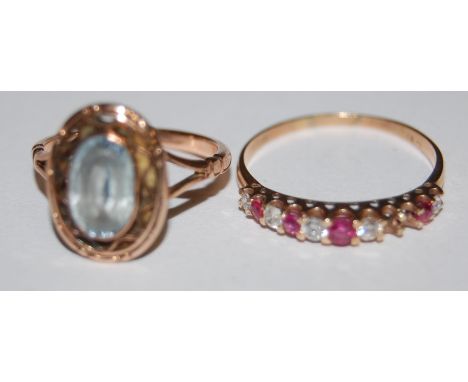 A 9ct gold ruby and diamond set dress ring (2 stones missing), and one other yellow  gold aquamarine set ring (2)