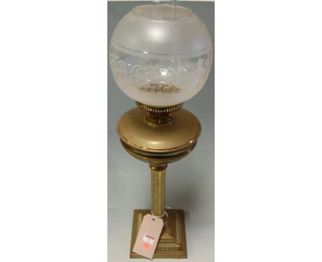 A circa 1900 lacquered brass pedestal oil lamp with shade 