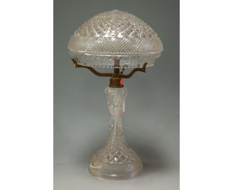 A cut crystal table lamp and shade, having lacquered brass fittings 