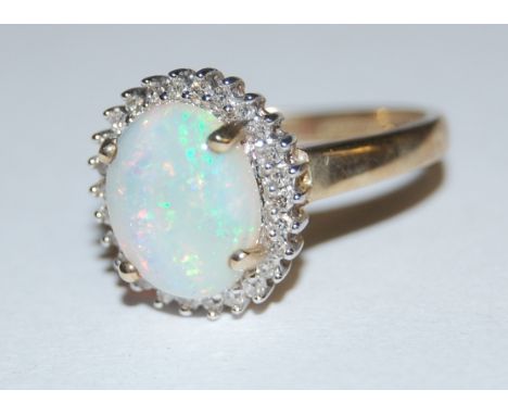 A modern 9ct gold four claw cabochon opal and diamond point set cluster ring Condition Report / Extra Information Condition g