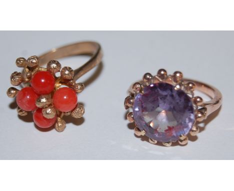 A ladies 9ct gold amethyst set dress ring and one other yellow metal (stamped 9ct) coral set dress ring (2)