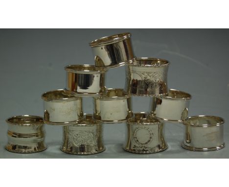 A set of six plain silver napkin rings; a pair of scroll leaf engraved napkin rings; and two other single examples (10) Condi