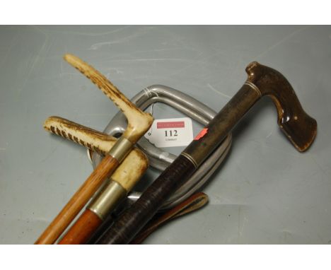 A shooting stick; antler handled walking cane; and three riding crops (5)