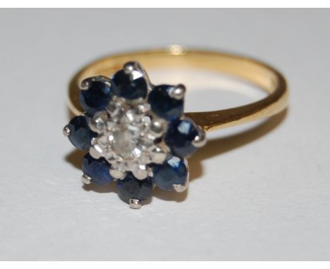 A ladies 18ct gold sapphire and diamond flower head cluster ring