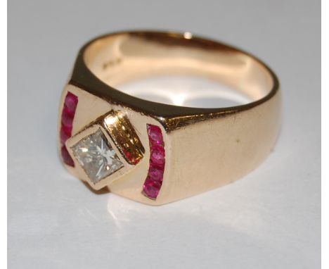 A modern gents 18ct gold dress ring set  with a princess cut diamond flanked to either side by four old cut rubies, gross wei