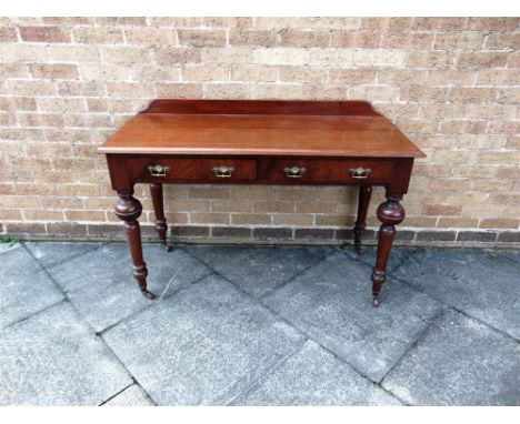 A VICTORIAN MAHOGANY SIDE TABLE  fitted with two frieze drawers, on turned supports with ceramic casters, 122cm wide 52cm dee