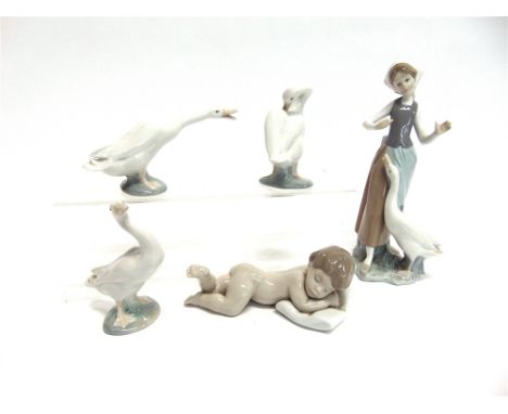 A LLADRO FIGURE OF A GIRL WITH A GOOSE  24cm high, another Lladro figure of a baby sleeping on a pillow, and three Lladro gee