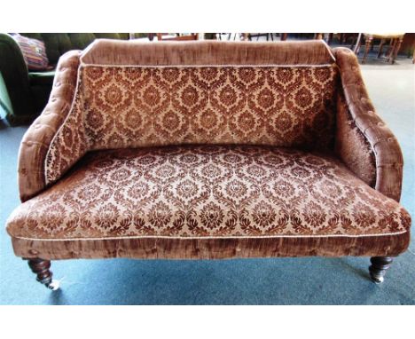 A BUTTON UPHOLSTERED TWO SEATER SOFA  on turned supports with ceramic casters, 143cm wide 87cm deep 78cm high