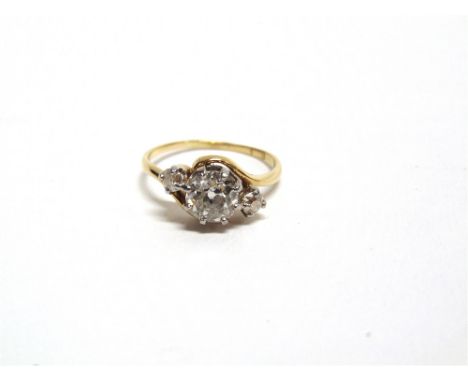 A THREE STONE DIAMOND RING stamped ;18ct', the old mine cut stone of approximately 1.25 carats, flanked by old brilliant cuts