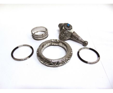 A HINGED BANGLE  stamped 'Sterling Silver', circa 1880, an Indian metalware anklet, a pair of Indian metalware and wooden ban