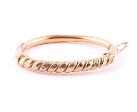 
	
		A FRENCH GOLD COLOURED HINGED BANGLE
		The hinged bangle with a rope twist front section, the concealed clasp with Frenc