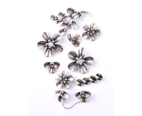 
	
		NIELS ERIK FROM, A COLLECTION OF VINTAGE SILVER COLOURED JEWELLERY 
		Comprising a flower head brooch with oval curved p