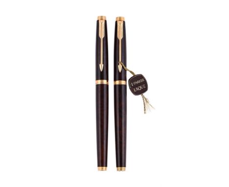 
	
		PARKER, 75 
		A BROWN LAQUE FOUNTAIN PEN AND ROLLER BALL PEN
		Cap and Barrel: With brown wood effect lacquered caps and