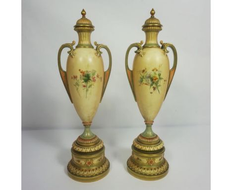 A pair of Royal Worcester blush ivory porcelain companion vases, with Registration Mark RN303838, 1957, decorated with thistl