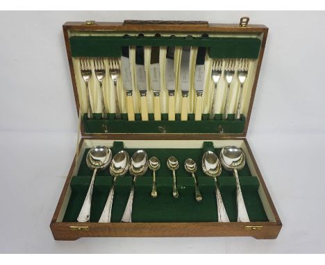 An Art Deco style case of silver plated flatware, for six place settings, with bone handled knives, table forks, spoons and s