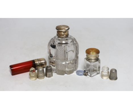 Three silver or white metal mounted glass scent bottles including enamelled, 56mm and ruby glass, one other, two glass stoppe