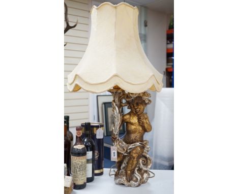 A gilt composition putti table lamp. 86cm tall