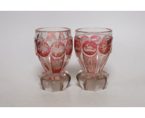 A pair of late 19th century Bohemian wheel engraved ruby stained glass beakers, 13.5cms high
