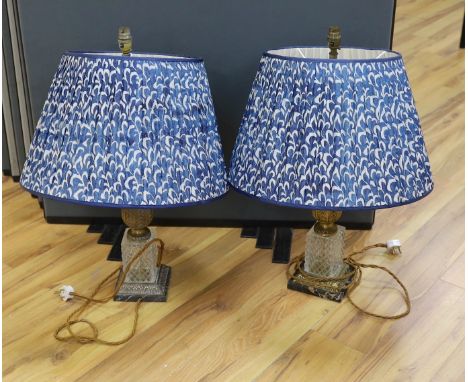 A pair of gilt brass and glass lamps with shades, 71cms high including light fitting