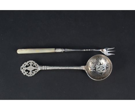A large silver sifting spoon with engraved decoration, hallmarked Newcastle 1873 by Reid &amp; Sons together with a mother of