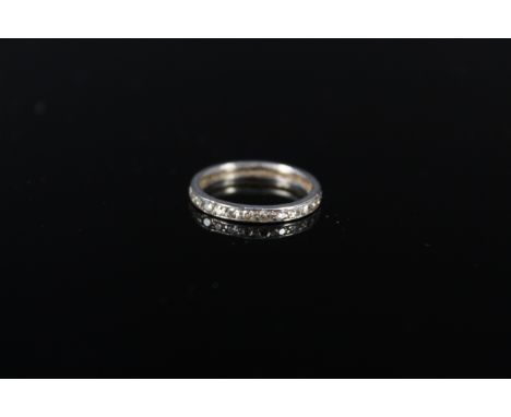 A white metal diamond set eternity ring, size J 1/2, approx 1.7g