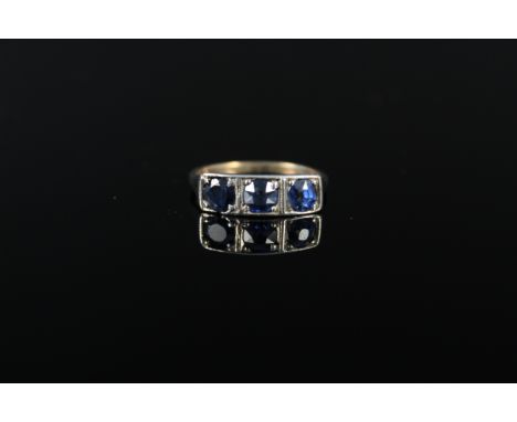 An unmarked yellow and white metal three stone set ring, size M, approx 2g (some damage to setting)