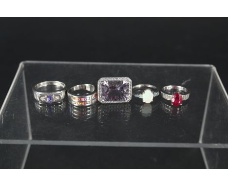 Five silver stone set rings including opal, tanzanite, quartz, ruby and sapphire, all with certificates