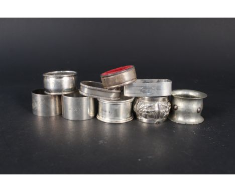 Seven silver napkin rings, a white metal oriental napkin ring and a white metal napkin ring, weighable silver approx 170g