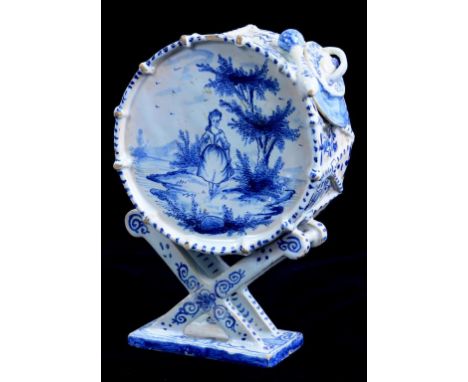 A DELFTWARE MODEL OF A DRUM PAINTED TO ONE SIDE WITH A GIRL IN A LANDSCAPE THE REVERSE WITH BOATS ON A LAKE, 14CM H, LATE 19T