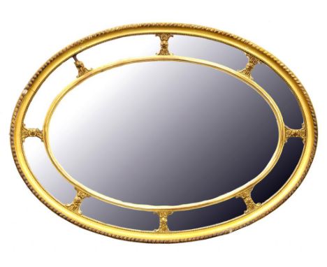 A VICTORIAN GILTWOOD AND COMPOSITION OVAL MIRROR 112CM W