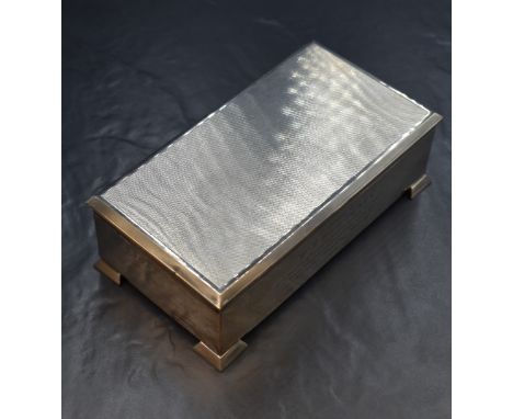 An Elizabeth II silver cigarette box, of hinged rectangular form, having engine turned decoration to the lid and personal ins