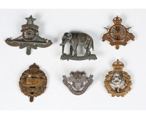 A large collection of British regimental cap and other badges, including India Artillery, Loyal Regiment, Army Cyclist Corps,