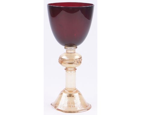 A 19th century German ruby and iridescent glass goblet,the domed foot having a band of German text, height 10", foot a/f.