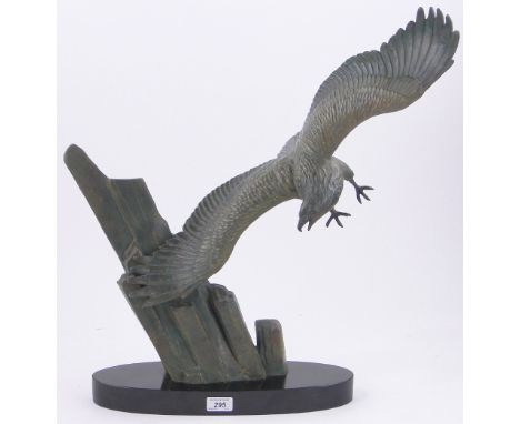 A continental bronze figure of an eagle with outstretched wings over cliffs,on oval marble plinth, marked Rulas, height 23.25