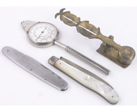 A sovereign scale,a silver and mother of pearl fruit knife 3.2", a penknife and a map measure.