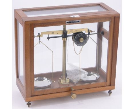 A 1950s brass mounted chemist's balance scale by Griffin & George Ltd, in glazed mahogany case, height 15.5".