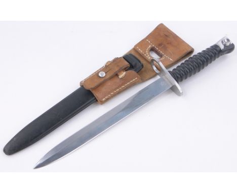 A German late 20th century bayonet,composition scabbard with leather frog marked Braunschweiler Sattler, overall length 15".