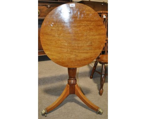 A 19th century mahogany tilt top table on turned column and tripod base, with brass castors, width 1'9", height 2'4".