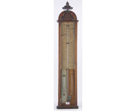 A Victorian carved oak cased Admiral Fitzroy barometer,by Mansfield of Shaftesbury with acanthus carved pediment, height 44".