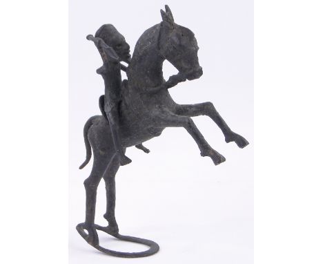 An African tribal patinated bronze figure of a huntsman on a rearing horse,height 11".