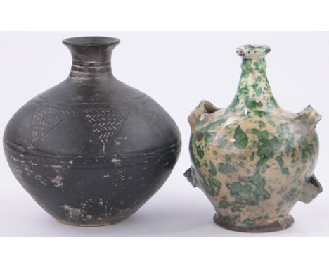 An 18th century French glazed terracotta wine flagon,with green mottled glaze, height 9" together with a black ceramic incise