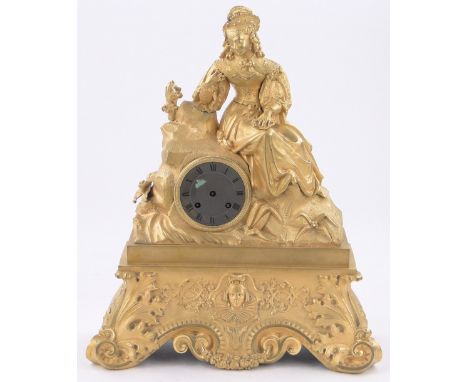 A continental ormolu ornate mantel clock surmounted by a figure of a lady, height 17".
