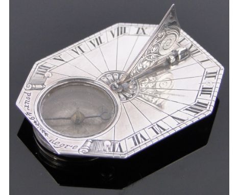 An 18th century French silver pocket sundial with elongated octagonal plate,engraved Gnomen and inset glazed compass, the und