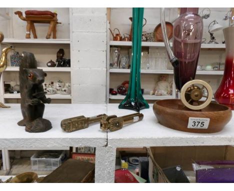 A bronzed metal squirrel nutcracker with glass eyes, a ship's wheel nutcracker and 2 brass nutcrackers