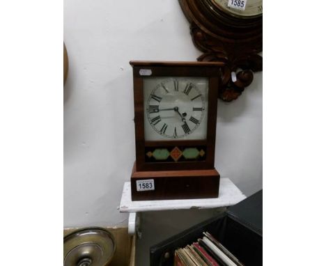 A postman's alarm clock with pendulum and key