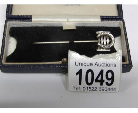A horse shoe stick pin (W Mansell)
