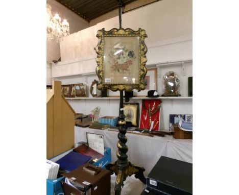 A 19th century pole screen with gold decoration and tapestry panel